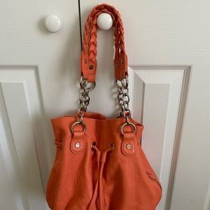Leather handbag orange color.